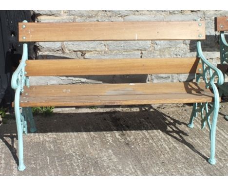 A cast iron ended garden bench, with Gothic lattice decoration, teak seat and back panel, "Carron 11" impressed to casting, 1