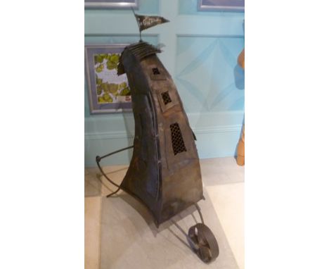 A late 20th century novelty tin sculpture, "The Egg Timer", depicting a hen coop on wheelbarrow type frame, with flag flying,