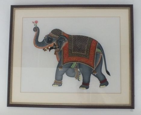 A Mughal style late 20th century Indian watercolour on silk panel. An elephant dressed for festival, in richly decorated ador