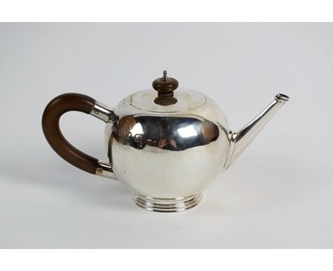 A silver Britannia standard bullet shaped teapot, Edwards & Sons, London 1936, of plain polished form with turned wood handle