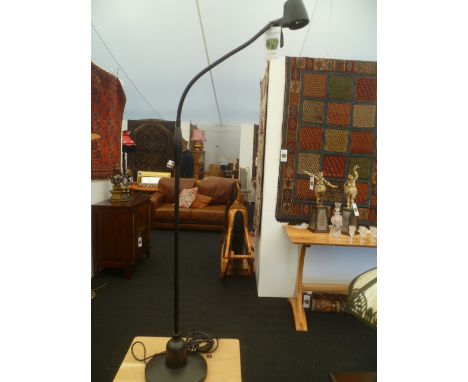 A contemporary black finished floor standing swan necked serious reader's light 