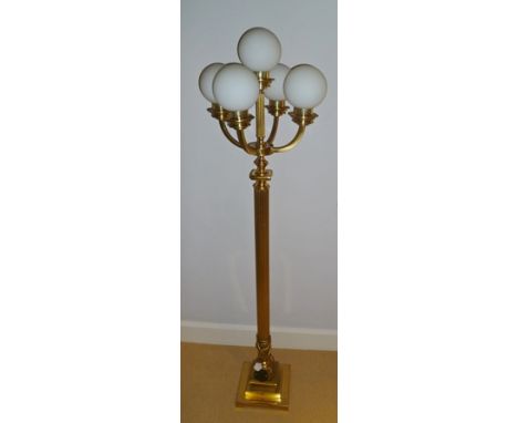 A brass standard lamp with five globe top 