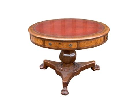 An early 19th century oak and pollard oak centre, or drum table, the top inset with tooled hide, crossbanded thumb nail mould