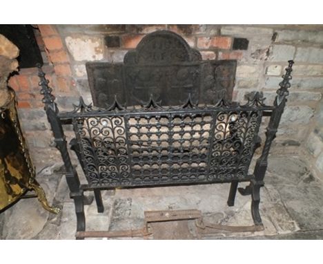 A 19th century iron fire grate, to the front a standing 19th century iron guard with pair of floral trellis doors, Gothic tra