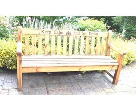 A late 20th century pine garden bench, varnished with motto to back rail,' Keep Calm and Sit Down', crown to centre, 183cm wi