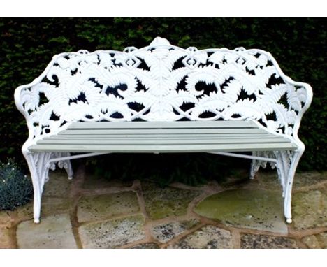 A 19th century Coalbrookdale cast iron bench of fern and blackberry design with wooden slatted seat, 154cm wide illustrated 