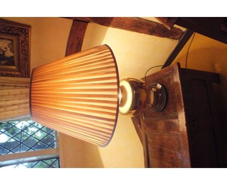 A brass table lamp of lidded jar design, on turned wood base, with cream pleated shade, 80cm high overall 