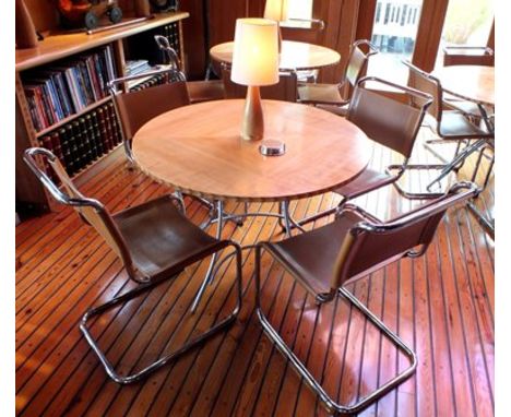 A maple veneer topped circular folding dining table, 1.06m diameter, together with a "Cadman" inlaid oak table lamp with crea