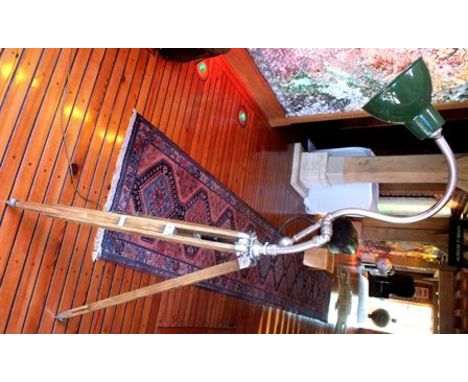 An Industrial design tubular metal standard lamp, with green enamel shade, raised on wooden adjustable tripod stand, 1.55m hi