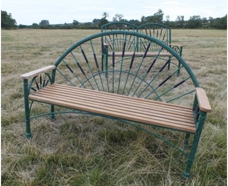 A 20th century cast metal garden bench, having green painted arched back with bound reeded frame, bulrush panels, planked sea