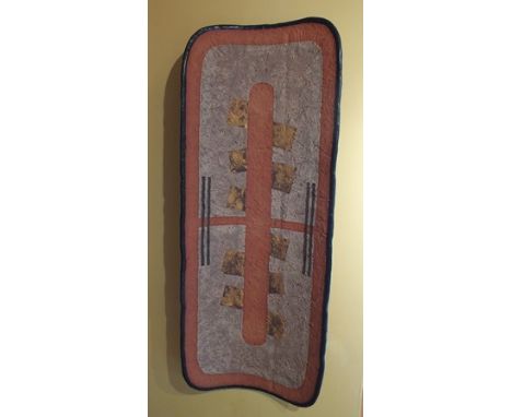 A studio ceramic wall panel, of bowed form decorated with an abstract design in black, terracotta and ochre, 67cm x 24cm 
