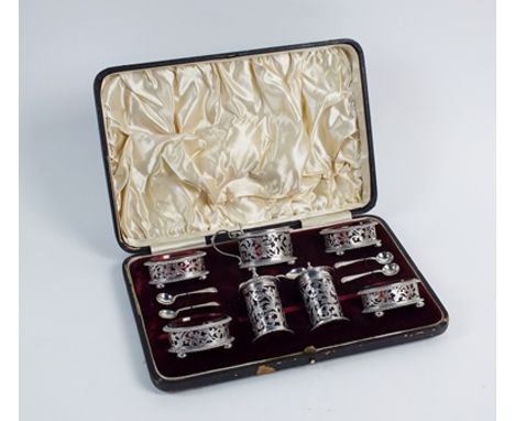 A cased Victorian seven piece silver condiment set, Walker & Hall, Birmingham 1897 & 1899, each piece of circular or oval for