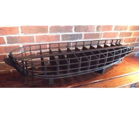 An 18th century Continental scale model of a wooden ship's hull skeleton, fruitwood constructed, raised on two blocks, 25cm w