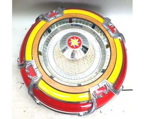 A "Rodeda" jukebox speaker, cast metal and mirrored, red yellow surround, 80cm diameter 