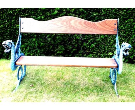 A garden bench with cast metal dragon ends, painted with wooden plank seat and serpentine back plank, 138cm wide, 90cm high 