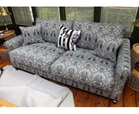 A contemporary deep seated sofa, upholstered in Liberty stylized floral charcoal tones, with scatter cushions, 2m wide 