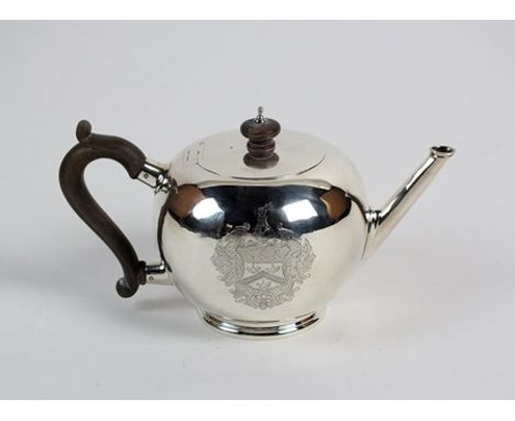 A silver Britannia standard bullet shaped teapot, L.A. Crichton, London 1923, of plain polished form with turned wood handle 