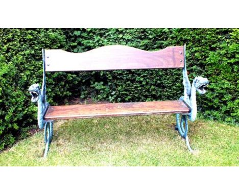 A garden bench with cast iron dragon ends, painted with wooden plank seat and serpentine back plank, 138cm wide x 90cm high 