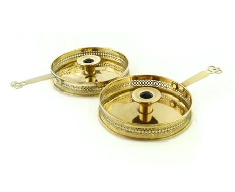 A pair of circular brass chamber sticks, with pierced gallery and projecting flat handle with pierced finial (2), 19cm diamet
