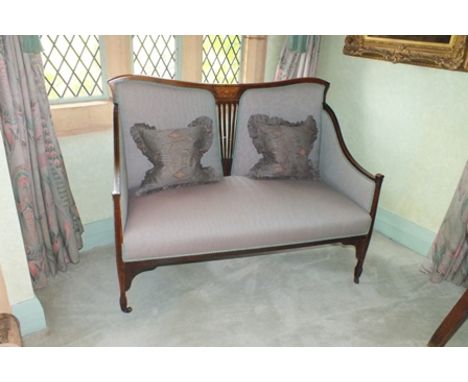 An Art Nouveau mahogany boxwood line strung two-seater sofa with serpentine top rail over a pierced centre splat, flanked by 
