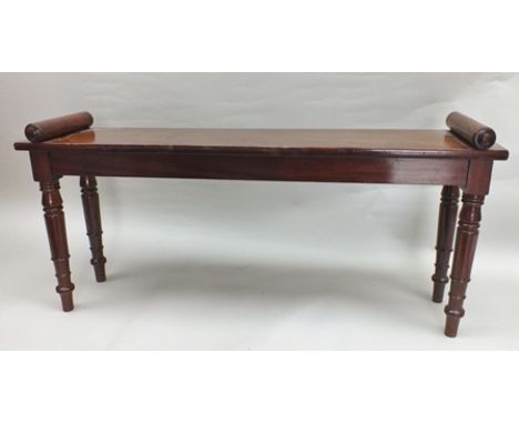 A George IV mahogany plain rectangular hall bench, with rouleau moulded ends, raised on ring turned supports, 1.10m wide 