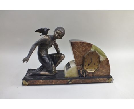 R. COUSYN An Art Deco mantel clock, with kneeling painted metal figure mount, inscribed "R. Cousyn a Hazebrouck", on a slate 