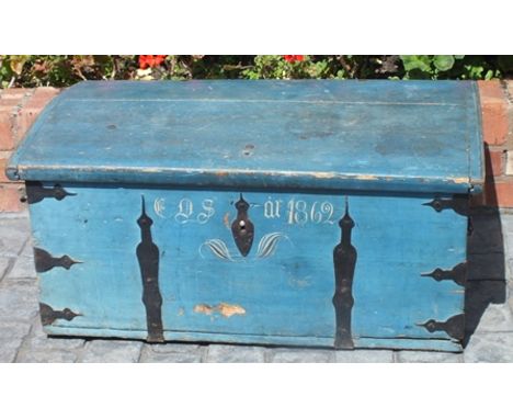 A 19th century painted pine dome topped trunk, with iron strapwork and carrying handles, opening to reveal a candle box, pain