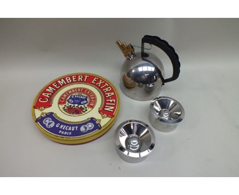 An "Alessi" copper bottomed hob kettle, two "Alessi" ashtrays and a "Camembert" ceramic stand, in original box 