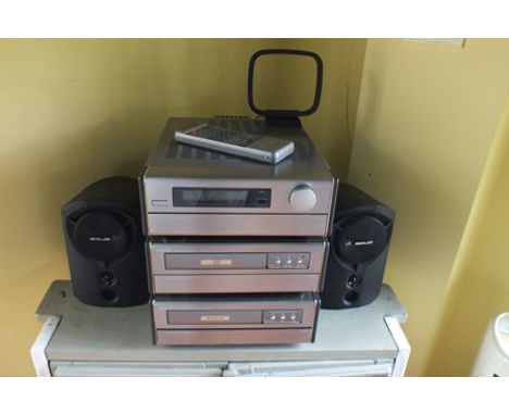 A "Denon" sound system with UDRA 70 radio, UCD 70 compact disc player, a UDR 70 cassette deck, and a pair of "solid" speakers