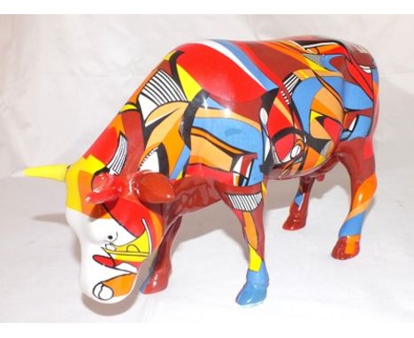 An early 21st century glazed ceramic cow figure, brightly coloured, from the "Cow Parade" series, 16cm high illustrated 