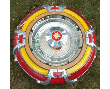 A "Rodeda" jukebox speaker, cast metal and mirrored red yellow surround, 80cm diameter 