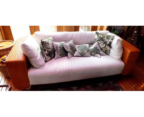 A contemporary sofa, having weave back frame with cream fabric upholstered seat and back, with scatter cushions, together wit