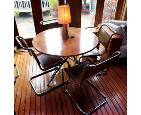 A maple veneer topped circular folding dining table, 1.06m diameter, together with a "Cadman" inlaid oak table lamp with crea