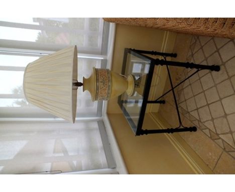 A yellow painted pottery based table lamp, together with a glass topped lamp table, on painted metal base 