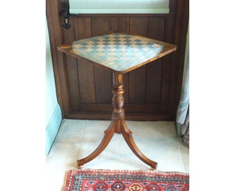 A Regency rosewood tripod games table, the crossbanded square top with rounded corners and chequer strung parquetry chessboar