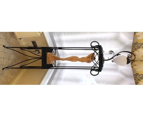 A free standing painted raffia and metal two-tier stand, the upper section housing a table light, having opaque glass shade, 