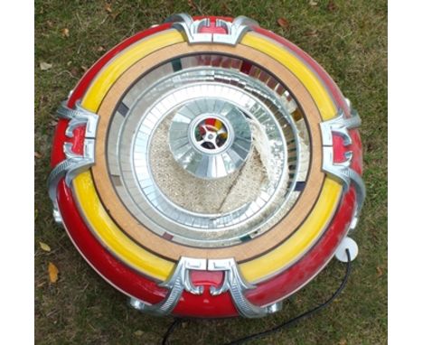 A "Rodeda" jukebox speaker, cast metal and mirrored red yellow surround, 80cm diameter 