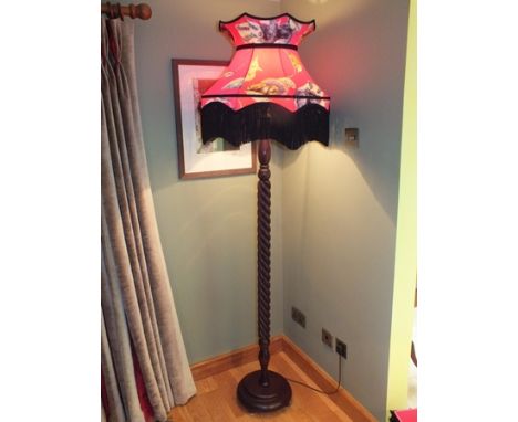 A modern reproduction lamp standard, the tassel-edged shade with images of wild animals by House of Hackett, 190cm high overa