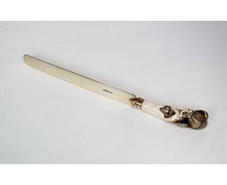 A Victorian silver gilt ivory mounted page turner, Henry Atkin, Sheffield 1885, with carved Japanese ivory handle depicting a