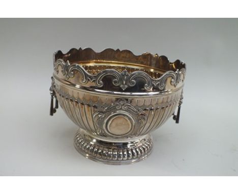 A late Victorian silver monteith, Martin Hall & Co, with scroll rim and fluted body, twin blind cartouche, lion mask handles,