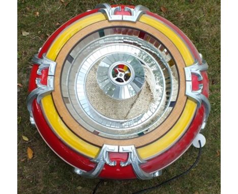 A "Rodeda" jukebox speaker, cast metal and mirrored red yellow surround, 80cm diameter 