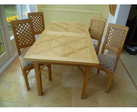 John Nethercott of Hereford A light oak dining suite, comprising rectangular topped table with lattice work frieze, supported