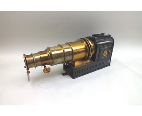 A late Victorian brass and tin plate magic lantern, bears impressed label, "patent no.2459", overall 58cm long, 23cm high 