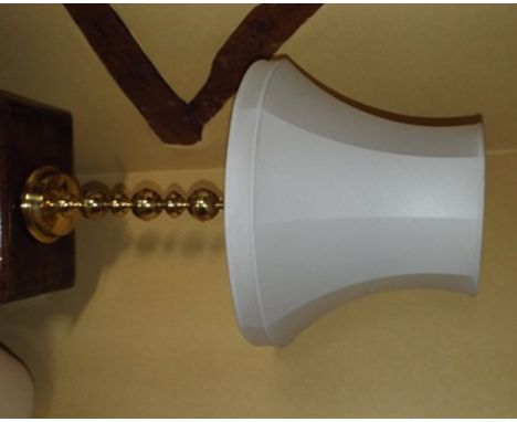 A large modern brass table lamp, with tapering cream shade, 93cm high overall, along with a stained beech wood lamp standard 
