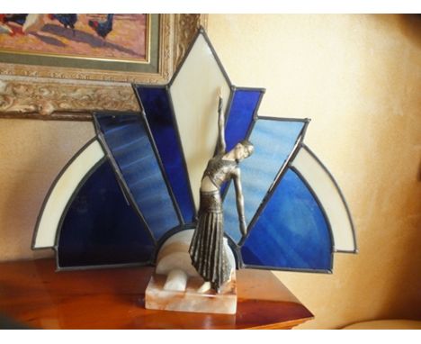 A modern Art Deco style figural lamp, the dancing figure standing on an onyx base, the single rose fitting behind stained gla