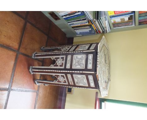 A Moroccan octagonal coffee table with mother-of-pearl and bone inlay, on an arch panel base frame, the top 46cm by 66cm illu