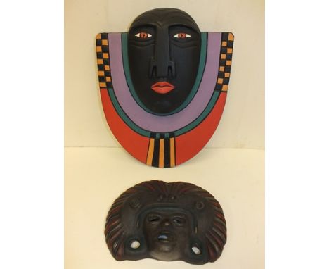 A Mexican ceramic mask and another wooden panel mask in the Art Deco style (2) 