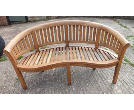 A "Global Teak" arched back garden bench, having splat back and serpentine seat, 1.58m wide, 87cm high illustrated 