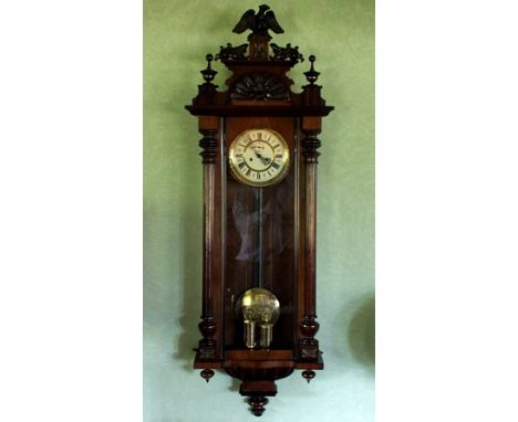 A 19th century walnut Vienna twin weight Regulator wall clock, the arched pediment with carved scallop front, twin finials be