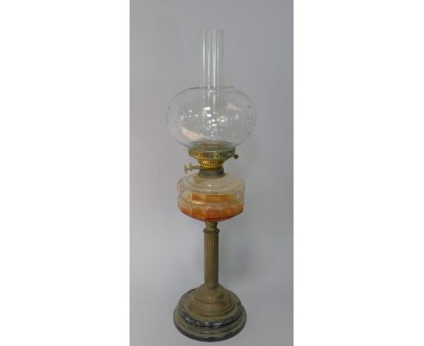 A late 19thC Veritas oil lamp, with moulded clear glass reservoir and on brass Duplex burner column and black glazed pottery 